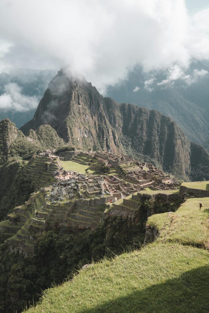 Experience the majestic beauty of Machu Picchu surrounded by clouds from Aguas Calientes, Peru.